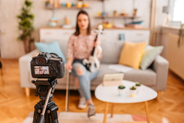 istock Musician filming a vlog on playing violin 1425505570