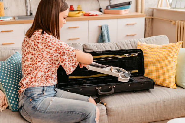 istock Young Woman Taking Out Her Violin From The Case 1425507097