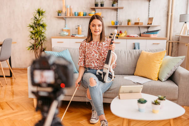 istock Musician filming a vlog on playing violin 1425507505