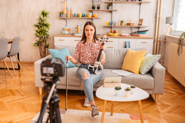 istock Musician filming a vlog on playing violin 1425507724