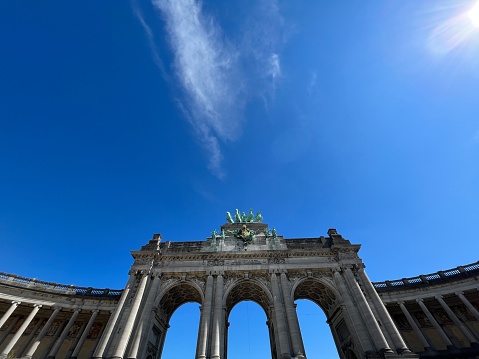 The Cinquantenaire  triumphal arch  with triple arch in Brussels under beautiful blue sky