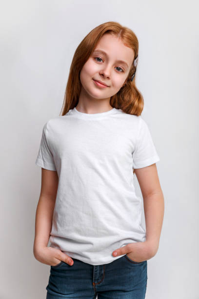 Kid in white t-shirt and jeans in studio stock photo