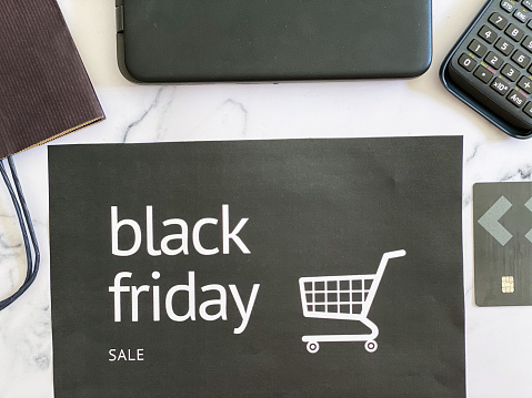 Background for black objects for Black Friday: credit card, laptop, calculator and paper bag