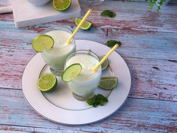 istock Glasses of milkshake decorated with mint and lime 1425515777