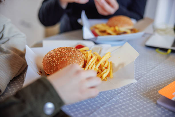 istock Eating burger and fries take out at home 1425515812