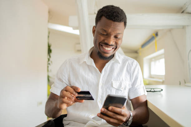 istock Cheerful man doing online shopping 1425517648