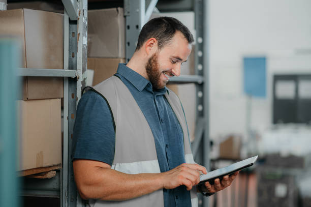 istock Logistics manager working on a digital tablet while standing by a shelf in an industry warehouse site. Happy industrial man worker checking stock inventory and delivery information on a mobile device 1425518811