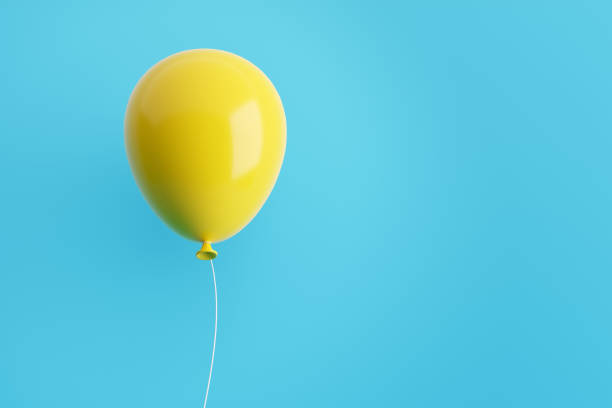 istock Yellow flying air helium balloon against blue background. 1425520226