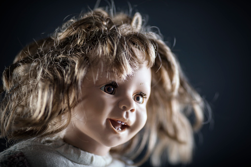 Vintage doll face on dark background