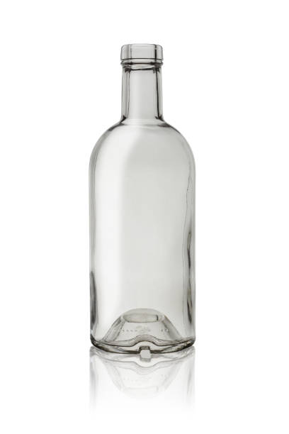 istock An empty open transparent glass bottle for liquids and beverages. Isolated on a white background with reflection. 1425527457