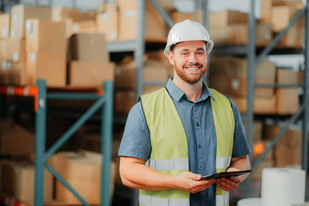istock Warehouse, logistics and happy man with a tablet working and planning a shipping delivery. Supply chain, industry and factory industrial plant worker with a smile taking inventory, stock or storage 1425527705