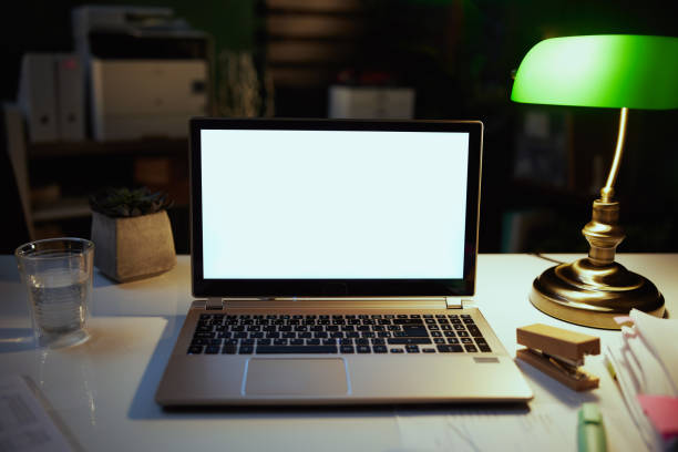 istock desk with laptop and lamp at night in modern office 1425527793