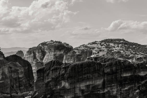 istock Black and white shot of pillar-like cliffs and mountain range with 2 biggest monasteries of Varlaam and Great Meteoron, Greece 1425528251