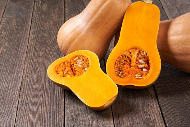istock whole and half fresh butternut squash on a wooden table. 1425530610