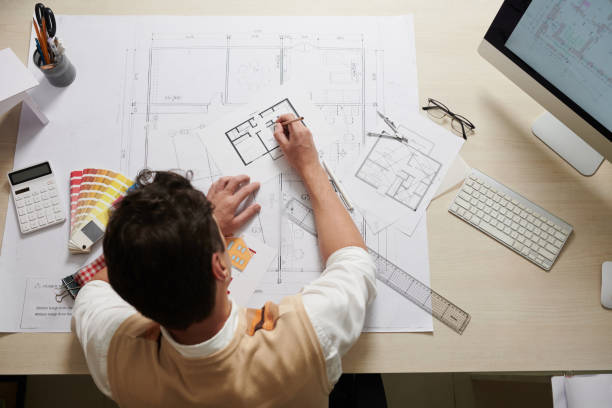 Architect Working with Blueprints Architect working with house blueprints, view from above civil engineer stock pictures, royalty-free photos & images