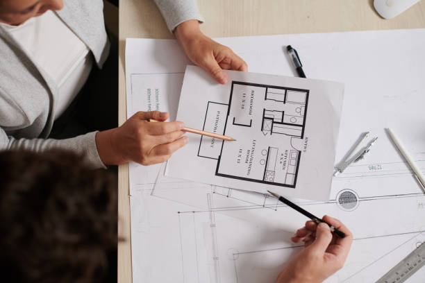 istock Architect and Designer Discussing Apartment Floor Plan 1425531574