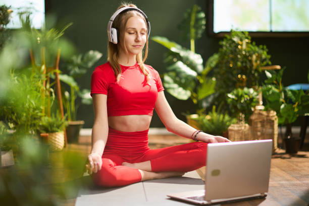 istock young female with laptop having webcam meeting and meditating 1425534357
