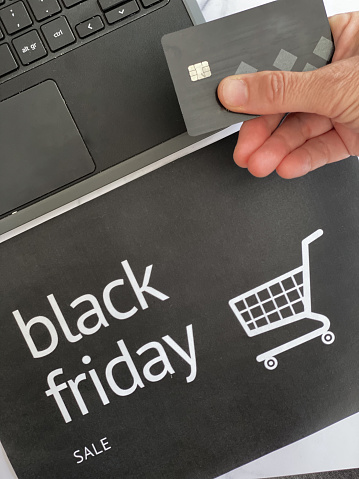Background for black objects for Black Friday: credit card, laptop, calculator and paper bag