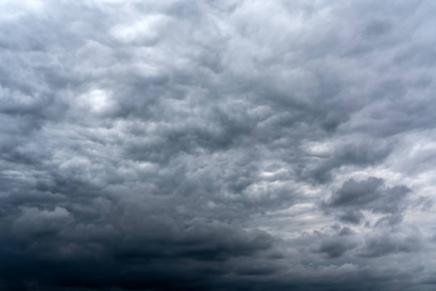 Dark cumulus thunderstorm clouds background stock photo