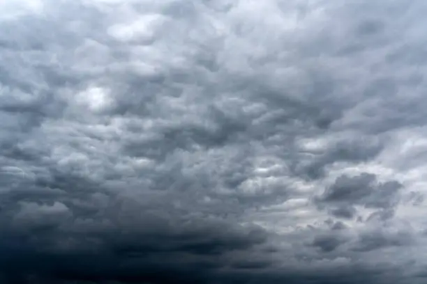 Dark cumulus thunderstorm clouds background