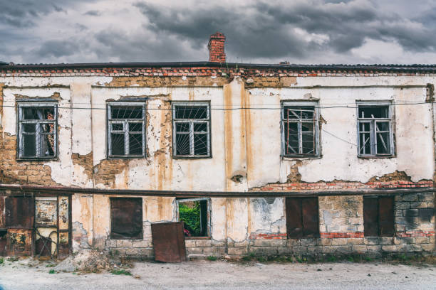 Old dilapidated ruined house in the city stock photo