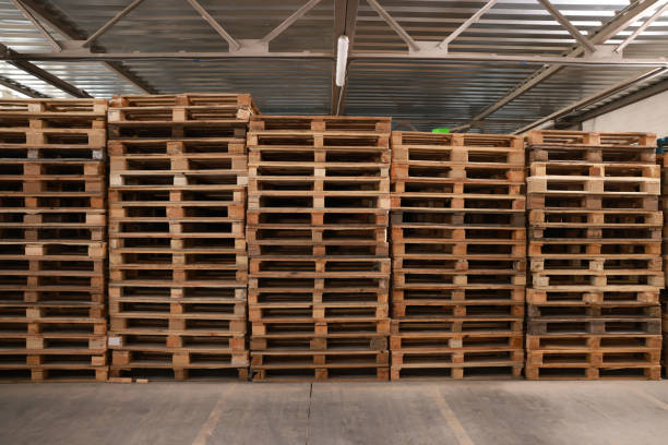 istock Many empty wooden pallets stacked in warehouse 1425541510