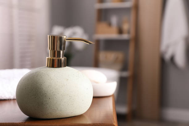 istock Dispenser with liquid soap on wooden table in bathroom, space for text 1425541934