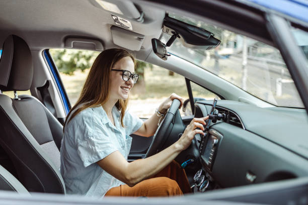 istock Young female driver sitting in the car and using smart phone 1425542669
