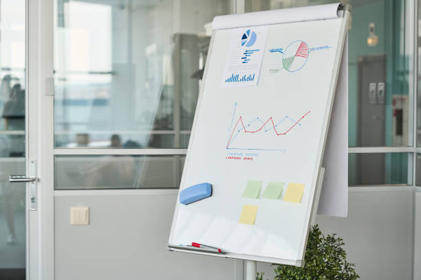 istock Whiteboard with financial document, notepapers, drawn graph and diagram 1425544105