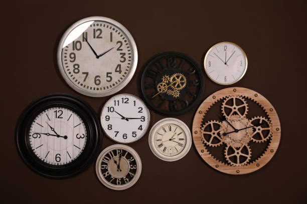 istock Collection of stylish clocks on brown wall 1425544163