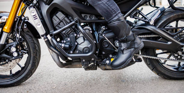 istock Man's legs with boots on sports motorcycle 1425544296