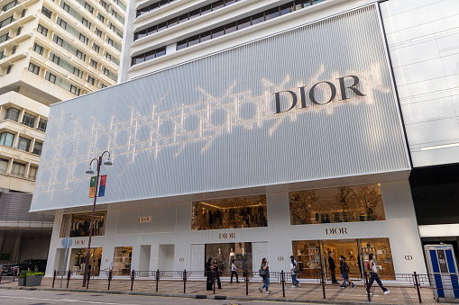 Hong Kong - September 17 , 2022 : Pedestrians walk past Dior store in Tsim Sha Tsui, Kowloon, Hong Kong.