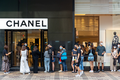 Hong Kong - September 17 , 2022 : Shoppers queuing outside the Chanel Boutique in Canton Road, Tsim Sha Tsui, Hong Kong.