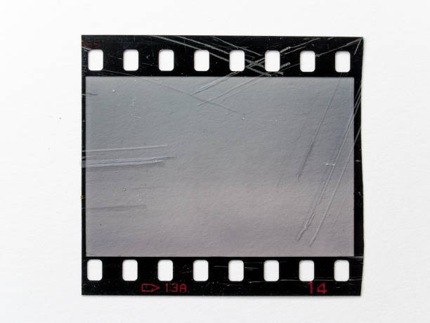 istock scratched empty 35mm filmstrip or snip on white paper background. 1425546670