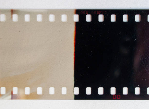 detail shot of 35mm film material on white paper background. stock photo