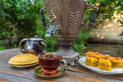 Tea drinking from a vintage samovar with oriental sweets