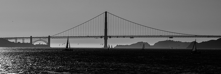 Black and White , boats in San Francisco Bay and Golden Gate Bridge at sunset.