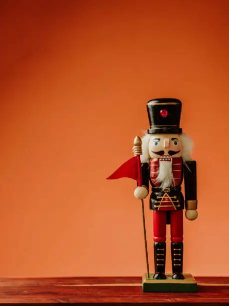 Christmas still life with knick knack nutcracker decoration ornament
Red and warm orange background, still life with copy space