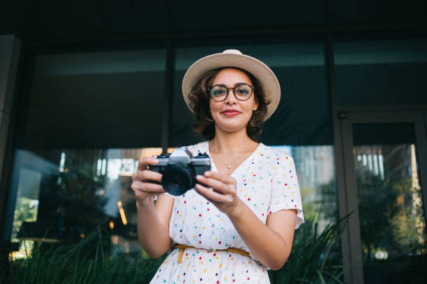 istock Stylish photographer in hat looking at camera 1425552027