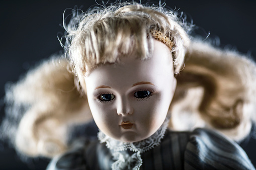 Vintage doll face on dark background