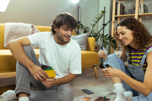 istock Young couple playing a board game on the floor 1425553608
