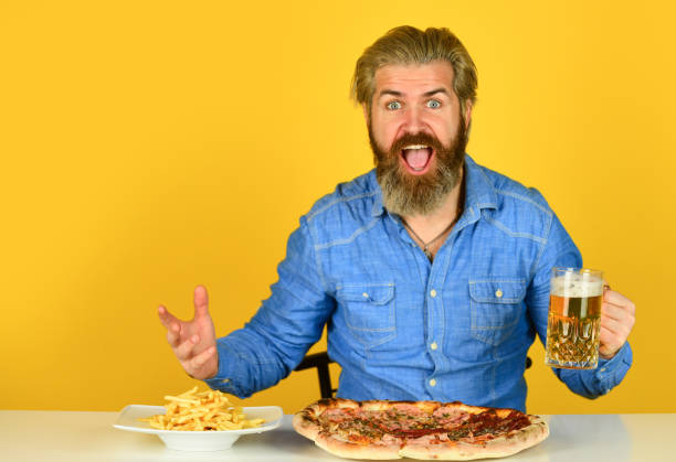 istock Pizza party concept. Big portion. Friday tradition. Dinner at pub. Hungry man going to eat pizza and drink beer. Finally pizza time. Pizzeria restaurant. Cheerful man bearded hipster eat pizza 1425553748