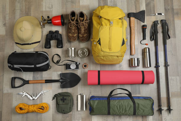 istock Flat lay composition with different camping equipment on wooden background. Traveler set 1425554118
