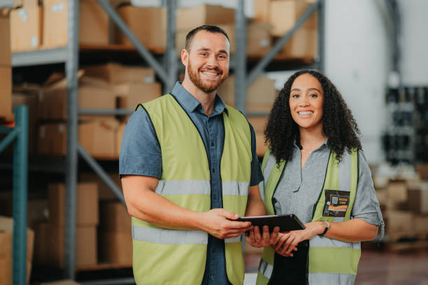 istock Logistics workers, employees and people working on tablet, doing stock check at factory and online for inventory in collaboration at a distribution warehouse. Portrait of team at industrial workshop 1425555093
