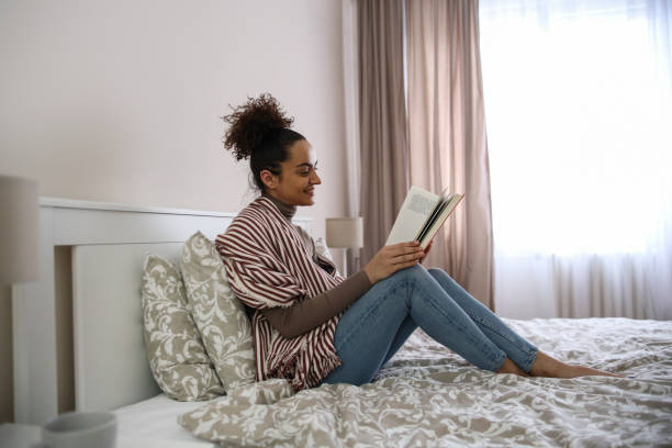 istock Young woman reading a book 1425555747