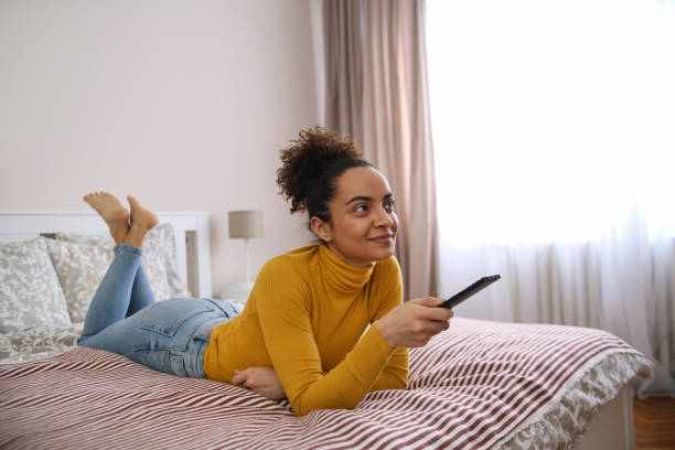 istock Young woman watching TV 1425555854
