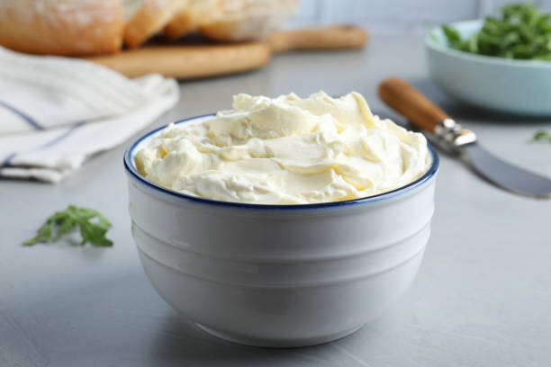 istock Bowl of tasty cream cheese on grey table 1425556397