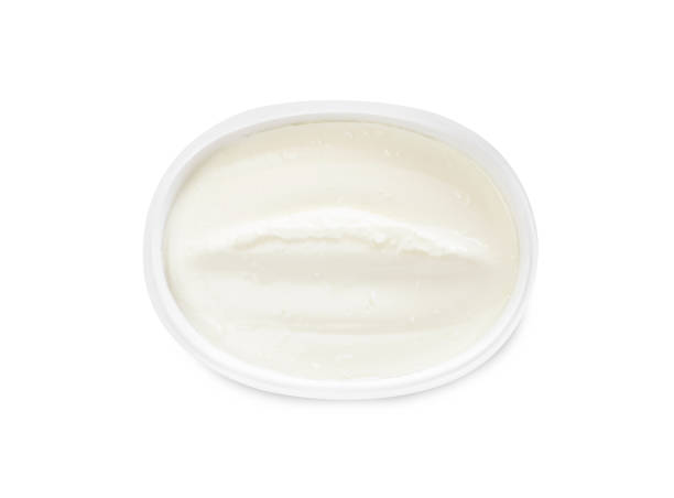 istock Plastic container of tasty cream cheese isolated on white, top view 1425556484