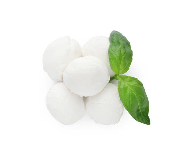istock Delicious mozzarella cheese balls and basil on white background, top view 1425556522