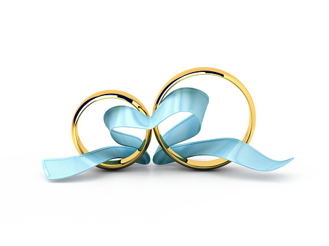 Wedding rings with a blue ribbon in a heart shape isolated on white.